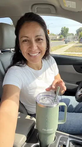 An actor in the driver's seat of a parked car talks to the camera beside an insulated tumbler in the cup holder, an ad for a travel tumbler.